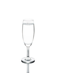 pure water over full in to wine glass isolated on white background with clipping path.