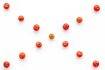 Fresh red tomatoes scattered on white background top view pattern