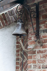 Obraz premium Marine bell with braided rope close up on brick wall