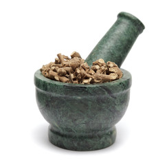 Organic Long pepper Dried roots (Piper longum) on marble pestle and over white background