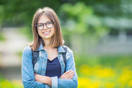 Portrait of attractive young teenage school girl with backpack