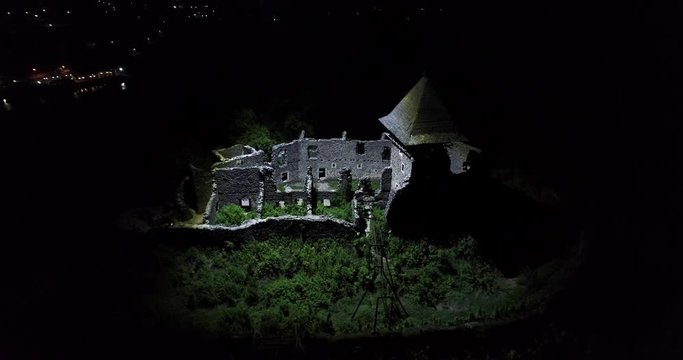 Aerial shot: The ruins of the old castle are illuminated with a powerful light. 90.00 lumen. 1000w led. Footage