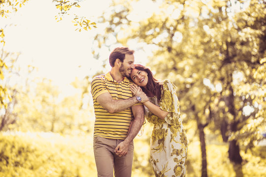 Happy Middle Age Couple Walking Trough Nature.