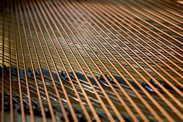 inside a piano, piano strings, copper, metal, steel, wooden, closeup, arranged, tuning