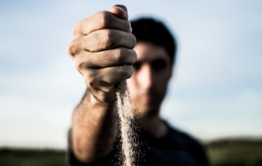  Young man's hand with sand © Facundo