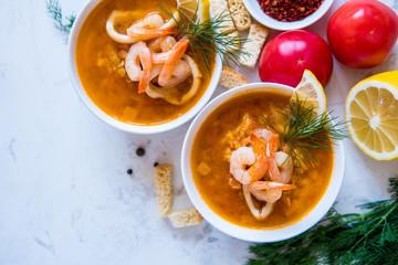 Lentil soup with seafood. Red soup with shrimps and squid
