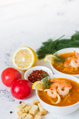 Lentil soup with seafood. Red soup with shrimps and squid