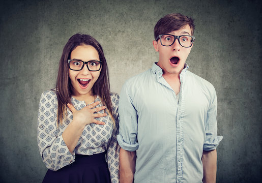 Shocked young couple in glasses