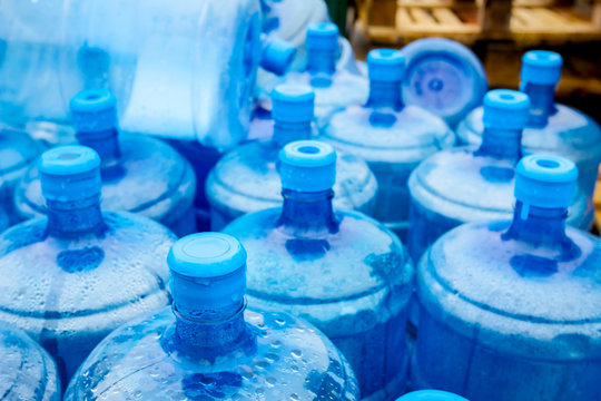 Big blue drinking water barrels, bottles, gallon, gets wet in the rain