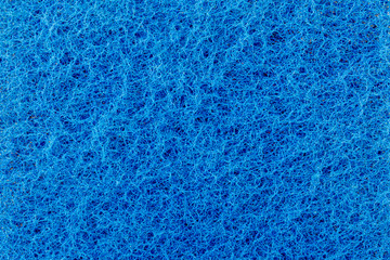 texture of a surface of intertwined blue threads, abrasive of a synthetic fiber, abstract background
