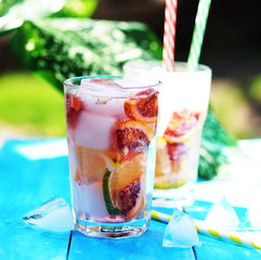 Summer cooling drink detox water from citrus lime, lemon, red orange and ice cubes on outdoor