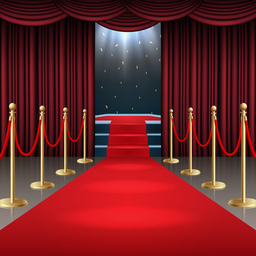 Podium with red carpet and curtain in glow of spotlights
