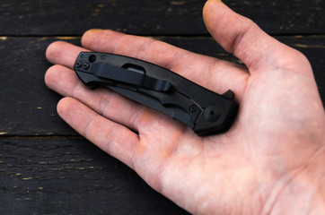 The knife is folded in the palm of your hand.