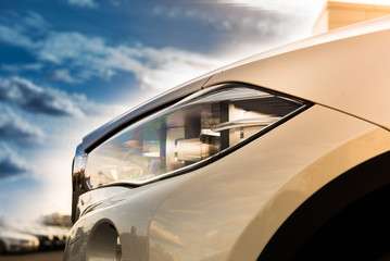 luxury white car head lamp. sunlight