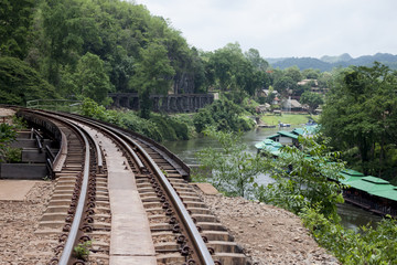 Fototapeta na wymiar Railroad tracks above the trees near the cliff with nature of river of history from World War 2 at Death Railway Kanchanaburi Province Thailand.
