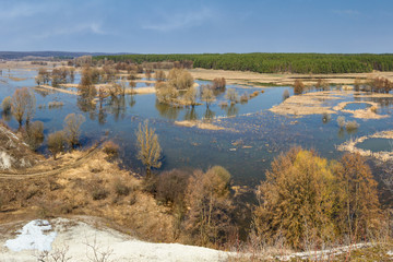 Spring landscape, banner - spring flood in river valley of the Siverskyi (Seversky) Donets, the winding river over the meadows between hills and forests, border region of Ukraine near to Russia