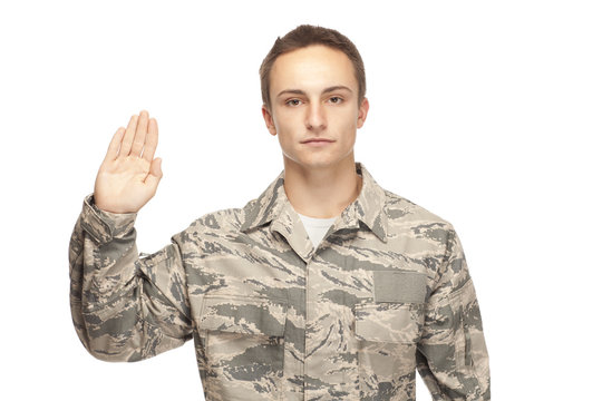 Air force airman with hand raised