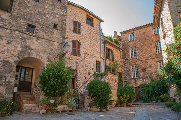 Fototapeta na wymiar View of old stone houses in alley under shadow, at the gorgeous medieval hamlet of Les Arcs-sur-Argens, near Draguignan. Located in the Provence region, Var department, southeastern France