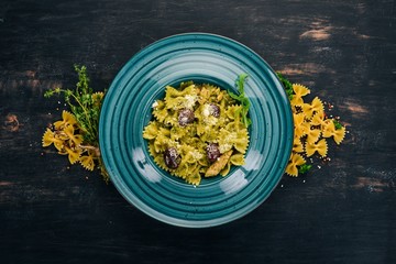 Pesto pasta. On a wooden background. Italian cuisine. Top view. Copy space.