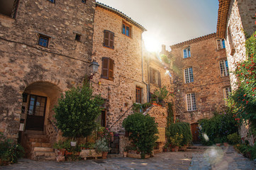 View of old stone houses in alley under shadow, at the gorgeous medieval hamlet of Les Arcs-sur-Argens. Located in the Provence region, Var department, southeastern France. Retouched photo
