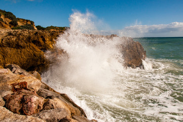 Big waves of Atlantic Ocean are splashing to the sea shore in Portugal city Albufera