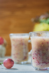 Grape smoothie over the white table.