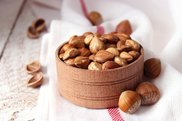 Peeled hazelnuts on the background of wood. useful snack, proper nutrition. how to peel the nuts.