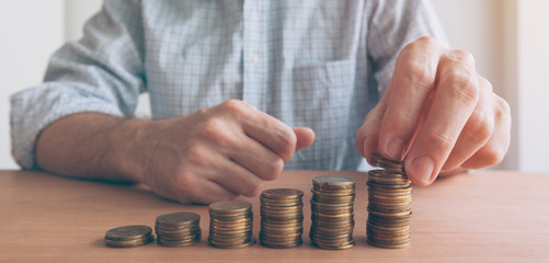 Finances and budgeting, businessman stacking coins