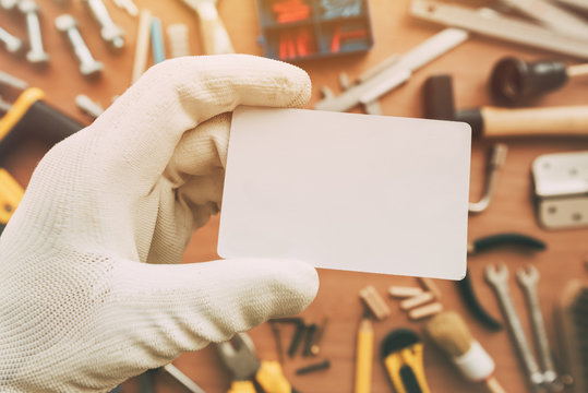 Worker holding blank business card as copy space