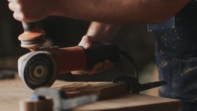 A man carpenter is working with wood using circular saw machine