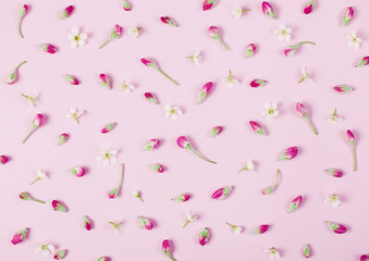 Naklejka premium Floral pattern made of spring flowers buds on pastel pink background. Flat lay. Top view.