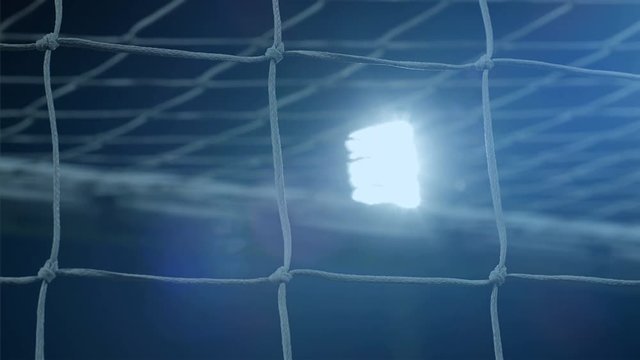 Background of football/soccer/sports stadium lights agains dark sky, net in front, 4k