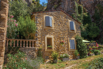 Obraz premium Alley view with house and flowers in Chateaudouble, a quiet and tourist village with medieval origin on a sunny summer day. Located in the Var department, Provence region, southeastern France