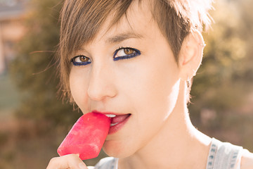 Close-up of a beautiful young woman eating ice cream