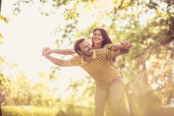 Happy and fun in nature. Middle age couple.