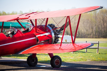 Vintage red plane ready to fly on the field © PhotoSpirit
