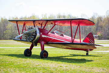 Vintage red plane ready to fly on the field