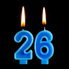 Burning birthday candles in the form of 26 twenty six for cake isolated on black background. The concept of celebrating a birthday, anniversary, important date, holiday