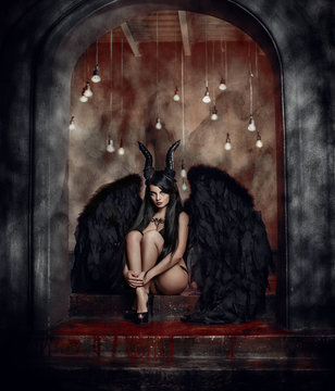 A devil with horns and black long hair. Mystical image of fantasy.