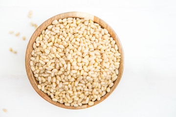 Shelled Raw Pine Nuts in the Wooden Bowl