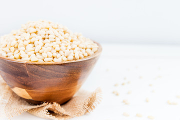 Shelled Raw Pine Nuts in the Wooden Bowl