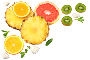Fototapeta na wymiar healthy background. slices of grapefruit, kiwi fruit, orange and pineapple isolated on white background top view