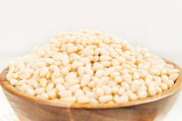 Shelled Raw Pine Nuts in the Wooden Bowl