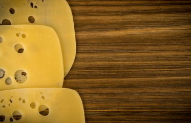 Sliced Cheese Over Rustic Wooden Background