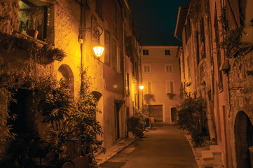 Night view of alley with walls and stone houses in the village of Vence, a stunning medieval town completely preserved. Located in the Alpes-Maritimes department, Provence region, southeastern France