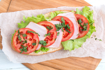 baguette sandwich with ham, tomatoes and lettuce