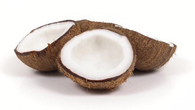 Four ripe tropical coconut halves with yummy white pulp rotating on white isolated background. Healthy fresh tropical fruits. Loopable seamless cocos rotating