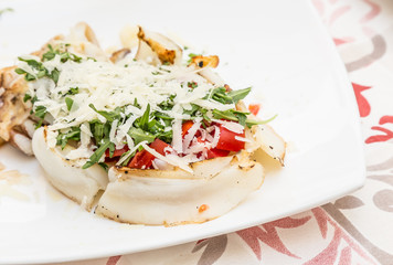 Cuttlefish with tomato, salad and Parmigiano cheese