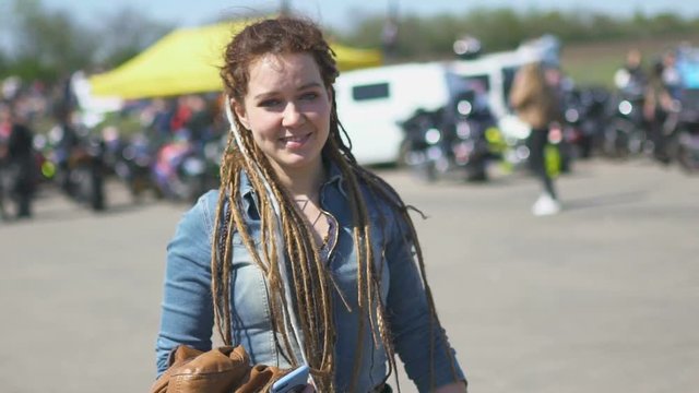 Young hipster woman with dreadlocks on street street