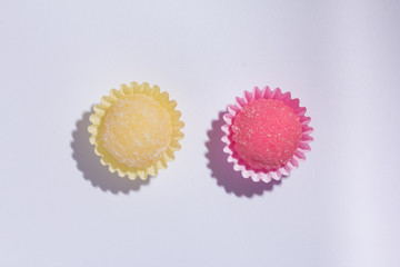 Brazilian sweets: Beijinho and Bicho de Pe. Children birthday parties. Flat lay design of candy ball. Macro, close up.